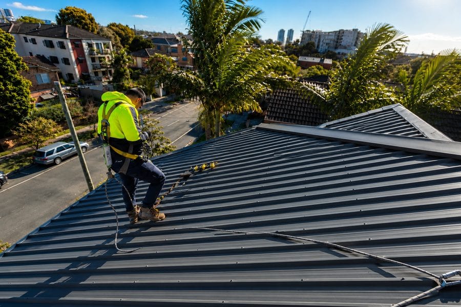 Technician working on a roof height safety system